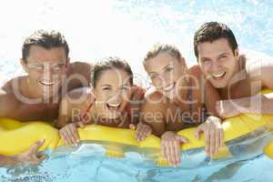 Group of Young friends having fun in pool