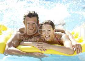 Young couple having fun in pool