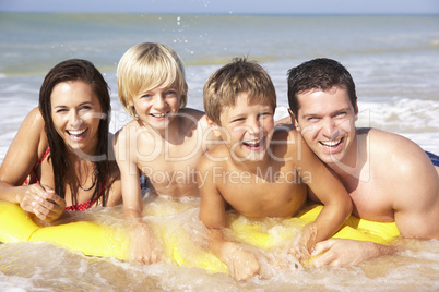 Young family pose on beach