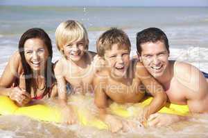 Young family pose on beach