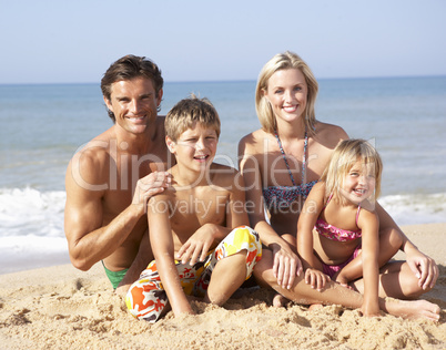 Young family pose on beach