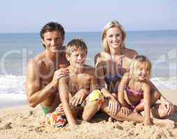 Young family pose on beach