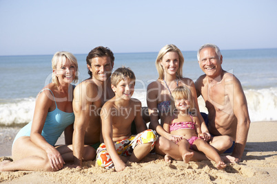 Three generation family pose on beach