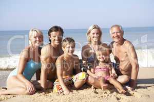 Three generation family pose on beach