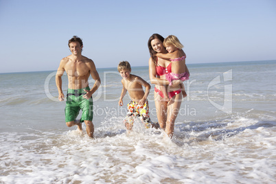 Young family play on beach