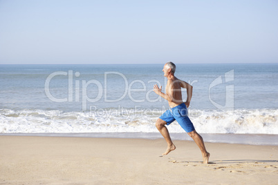 Senior man running on beach