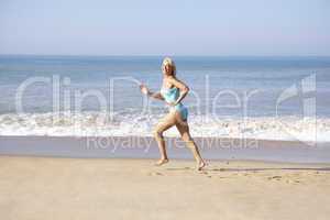 Senior woman running on beach