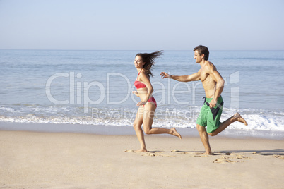 Young couple running on beach