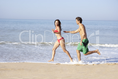 Young couple running on beach