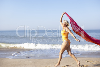 Senior woman walking on beach