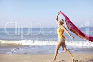 Senior woman walking on beach