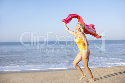 Senior woman running on beach