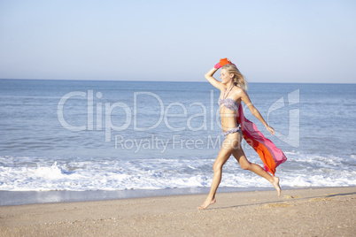 Young woman running on beach