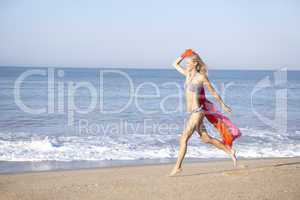 Young woman running on beach