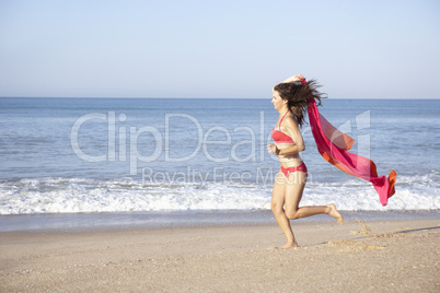 Young woman running on beach