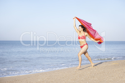 Young woman running on beach