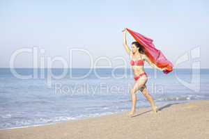 Young woman running on beach