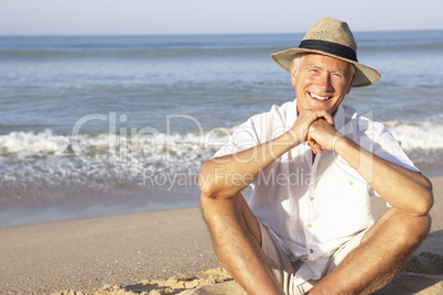 Senior man sitting on beach relaxing