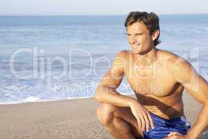 Man sits on beach relaxing