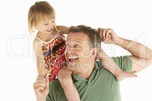 Young man carries child on shoulders