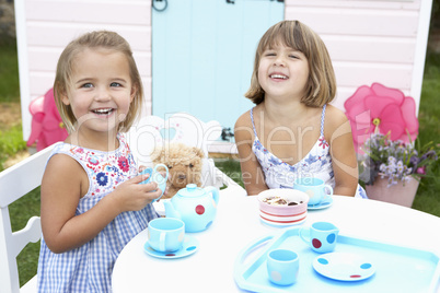 Two young girls play outdoors