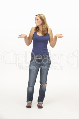 Young woman poses with shrugged shoulders