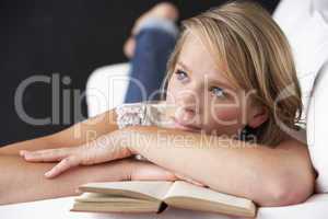 Studio Portrait Of Teenage Girl Reading Book