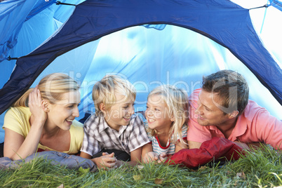 Young family poses in tent