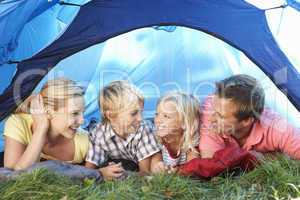 Young family poses in tent