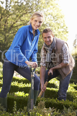 Young couple working in garden