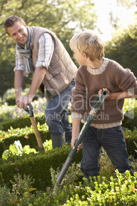 Young man with child working in garden