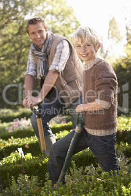 Young man with child working in garden