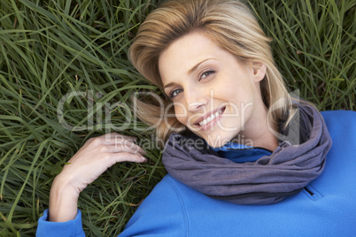 Young woman lying alone on grass