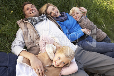Young family lying together on grass