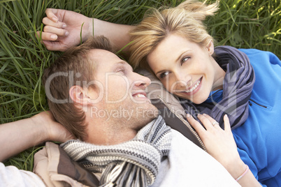 Young couple lying together on grass