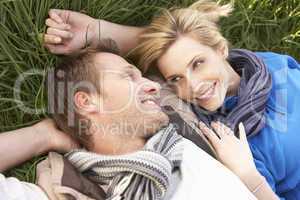 Young couple lying together on grass