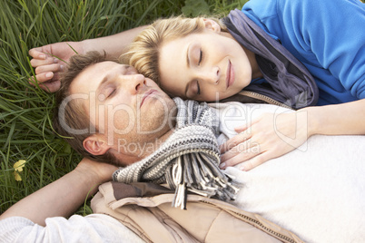 Young couple lying together on grass