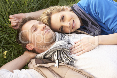 Young couple lying together on grass