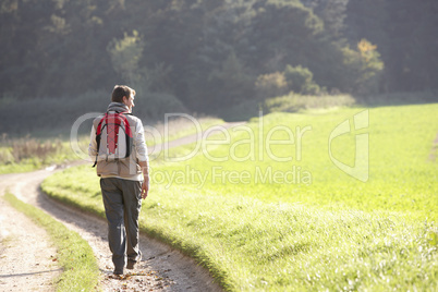 Young man walks in park