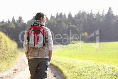Young man walks in park