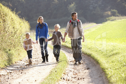 Young family walking in park