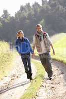 Young couple walking in park