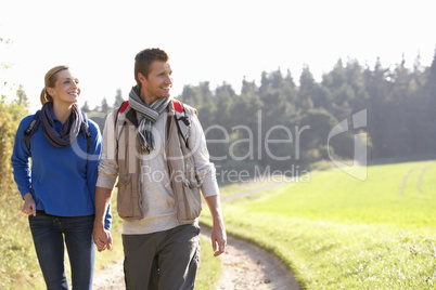 Young couple walking in park