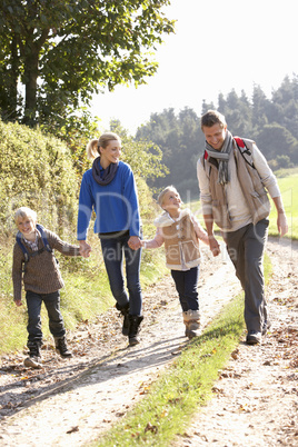 Young family walking in park