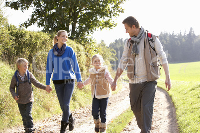 Young family walking in park