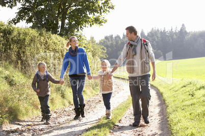 Young family walking in park