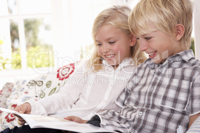Two young children read together