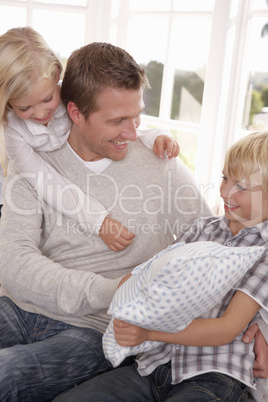 Man and children play together