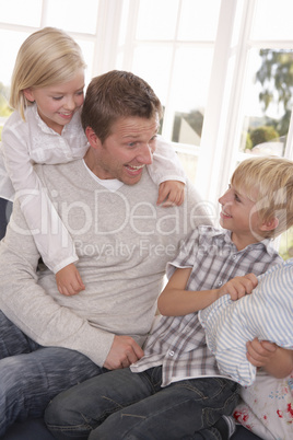 Man and children play together