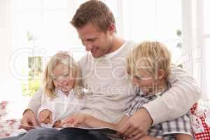 Man and children reading together